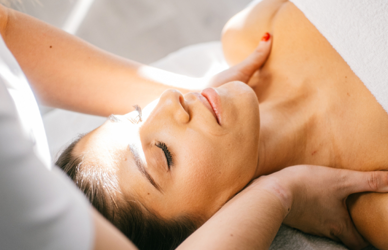 Image of a woman receiving a wellness treatment from a physiotherapy professional.