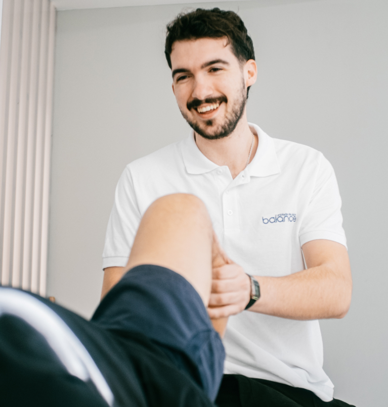 Picture of a ForPhysio professional helping her patient with a stretching exercise.